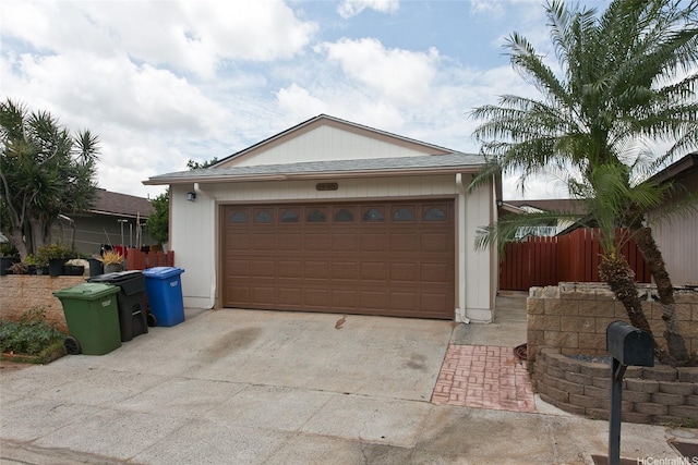 exterior space featuring concrete driveway and fence