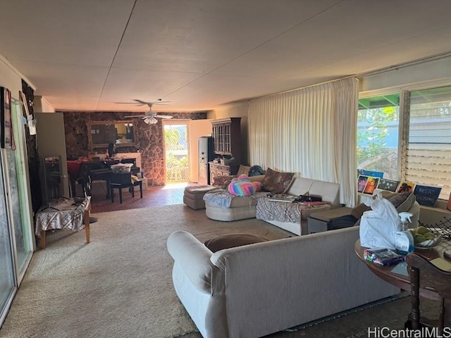 living area featuring a wealth of natural light and ceiling fan