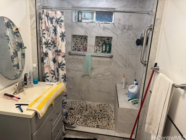 full bath with vanity and tiled shower