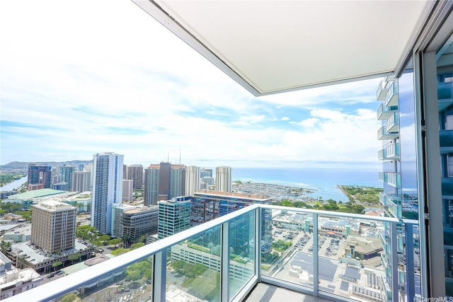 balcony featuring a city view and a water view
