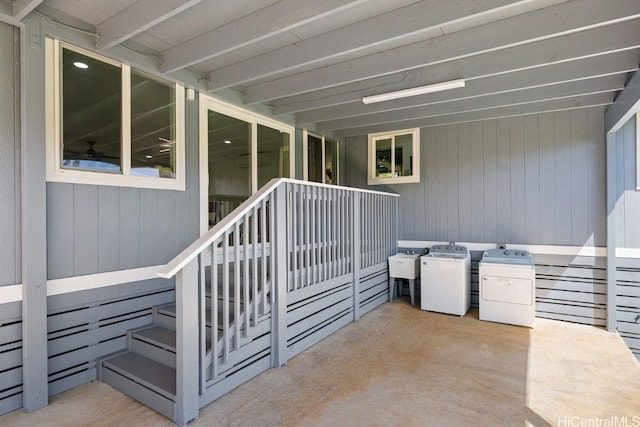 view of patio featuring washing machine and clothes dryer and a sink