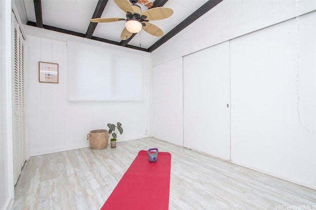 workout room featuring ceiling fan and wood finished floors
