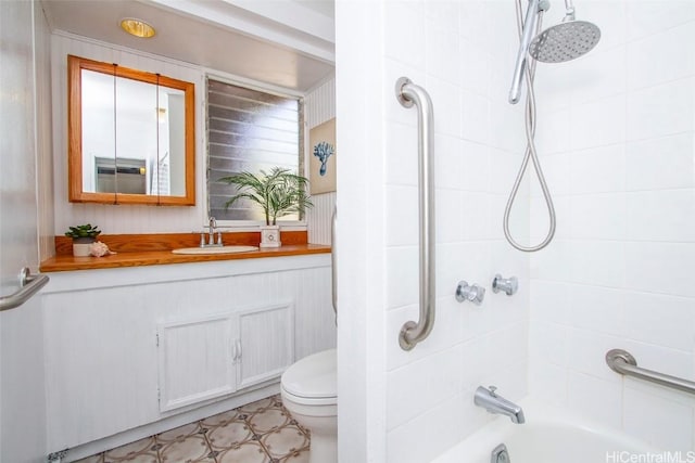 bathroom with toilet, vanity, and shower / washtub combination