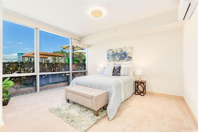 bedroom featuring a wall unit AC, baseboards, and carpet floors