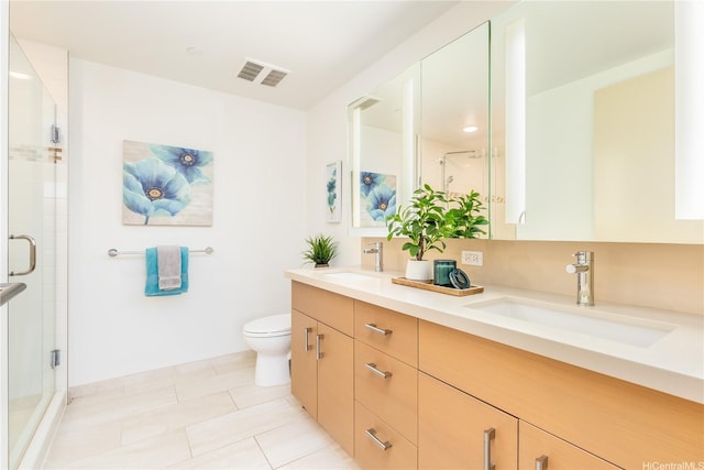 bathroom featuring a shower stall, a sink, and visible vents