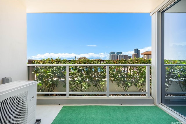 balcony with a city view and ac unit