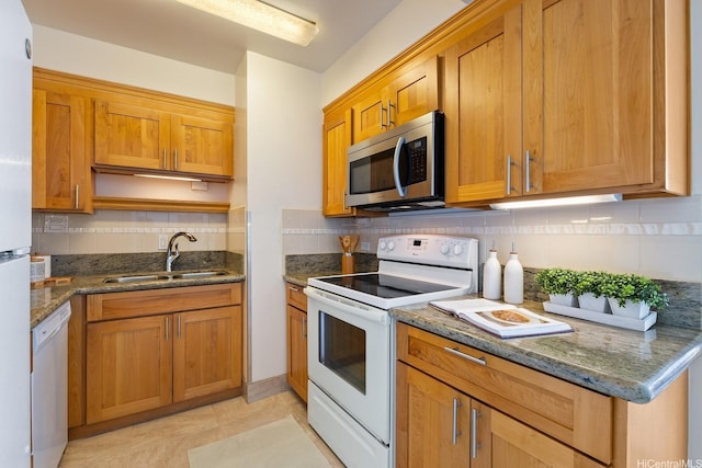 419 Atkinson Dr Unit 1603, Honolulu, HI 96814 - kitchen featuring white appliances, a sink, tasteful backsplash, and dark stone counters