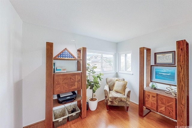 sitting room featuring wood finished floors