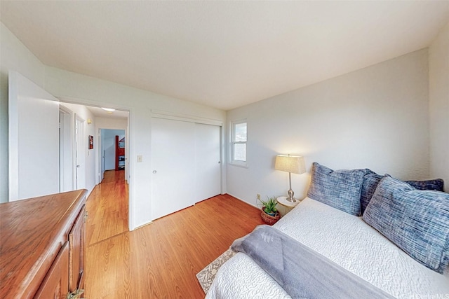 bedroom featuring a closet and light wood-style floors