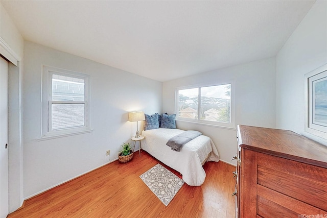 bedroom featuring light wood-style flooring and baseboards