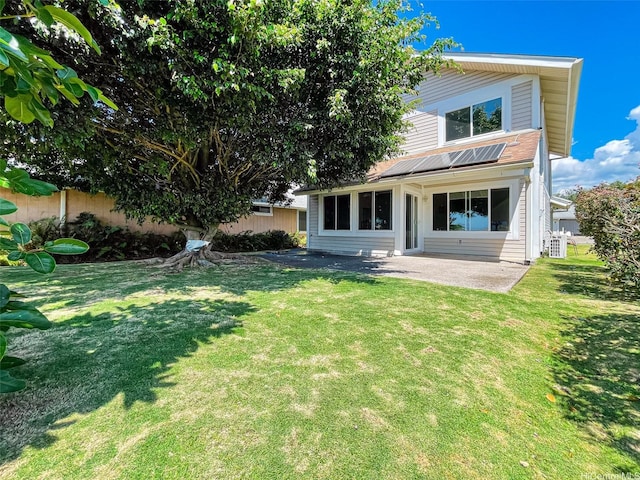 back of house featuring a patio area, fence, and a lawn