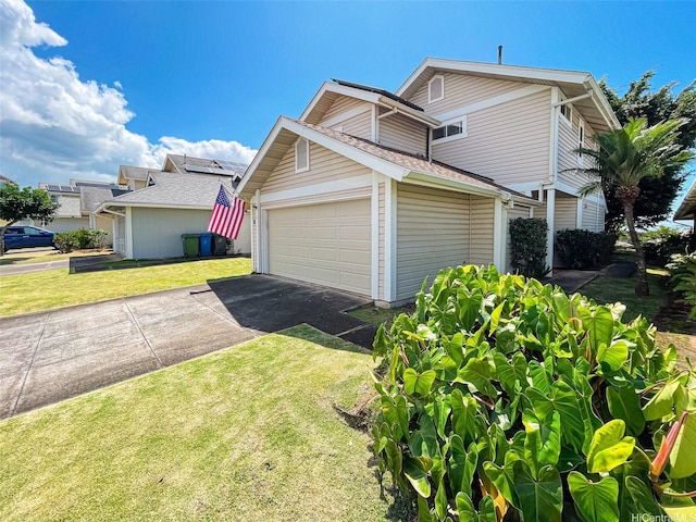 view of property exterior with a yard, aphalt driveway, and an attached garage