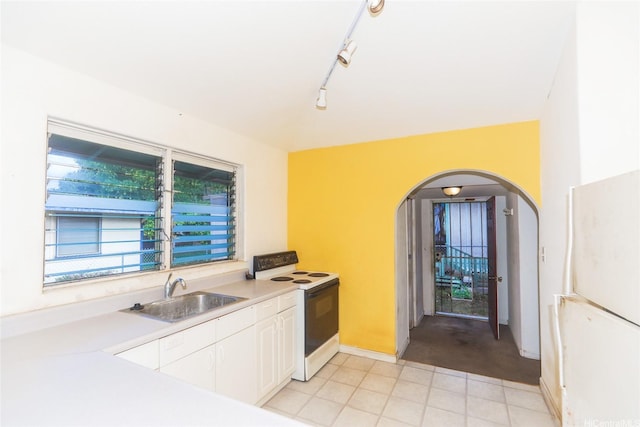 87-118 Alapaki St, Waianae, HI 96792 - kitchen featuring white range with electric stovetop, arched walkways, white cabinetry, light countertops, and light tile patterned floors