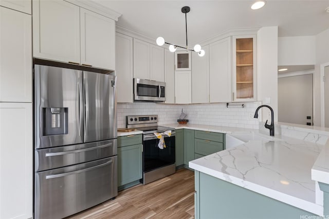 91-1159 Kanela St Unit M30, Ewa Beach, HI 96706 - kitchen featuring appliances with stainless steel finishes, a sink, backsplash, light stone countertops, and recessed lighting