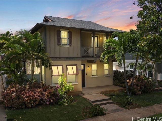 91-1036 Kaiuliuli St, Ewa Beach, HI 96706 - view of property featuring a balcony, board and batten siding, a porch, and roof with shingles