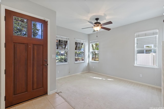 91-1036 Kaiuliuli St, Ewa Beach, HI 96706 - foyer entrance featuring baseboards, light colored carpet, a ceiling fan, and light tile patterned floors
