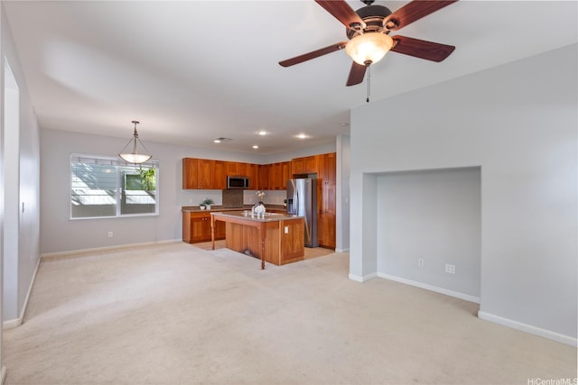 91-1036 Kaiuliuli St, Ewa Beach, HI 96706 - kitchen with stainless steel appliances, open floor plan, baseboards, brown cabinetry, and recessed lighting