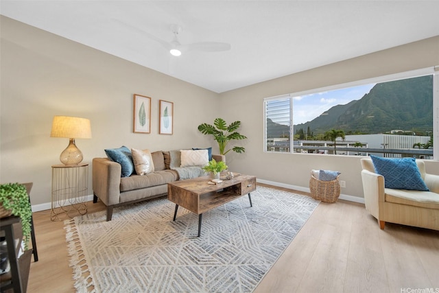 46-269 Kahuhipa St Unit D202, Kaneohe, HI 96744 - living room featuring a mountain view, wood finished floors, and ceiling fan
