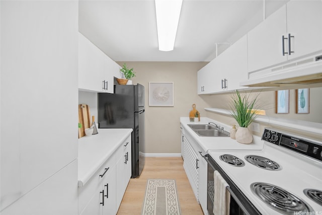 46-269 Kahuhipa St Unit D202, Kaneohe, HI 96744 - kitchen with electric stove, freestanding refrigerator, light countertops, under cabinet range hood, and white cabinetry