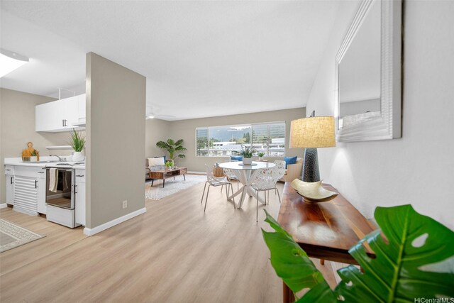 46-269 Kahuhipa St Unit D202, Kaneohe, HI 96744 - dining room featuring light wood-style floors and baseboards