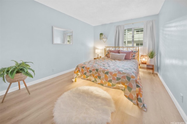 46-269 Kahuhipa St Unit D202, Kaneohe, HI 96744 - bedroom featuring wood finished floors and baseboards
