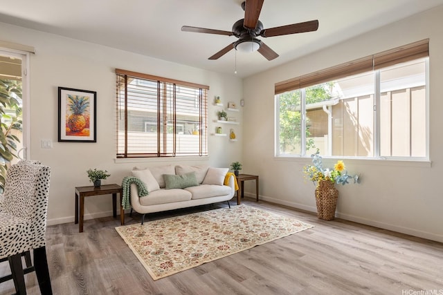 91-6221 Kapolei Pkwy Unit 511, Ewa Beach, HI 96706 - living area featuring wood finished floors, a ceiling fan, and baseboards