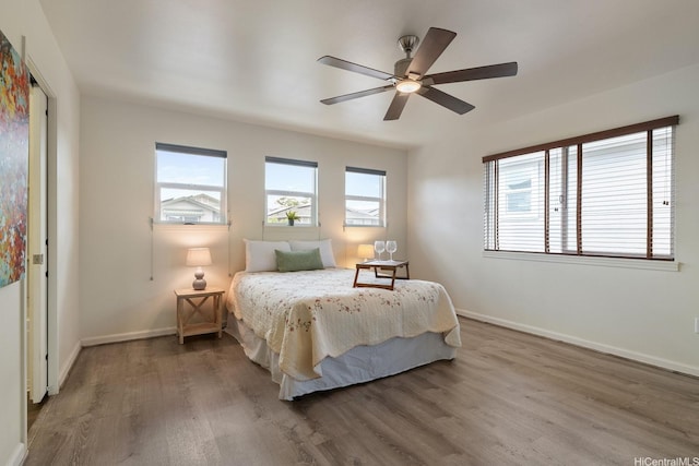 91-6221 Kapolei Pkwy Unit 511, Ewa Beach, HI 96706 - bedroom with wood finished floors, baseboards, and a ceiling fan
