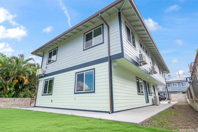 rear view of house with a lawn and a patio area