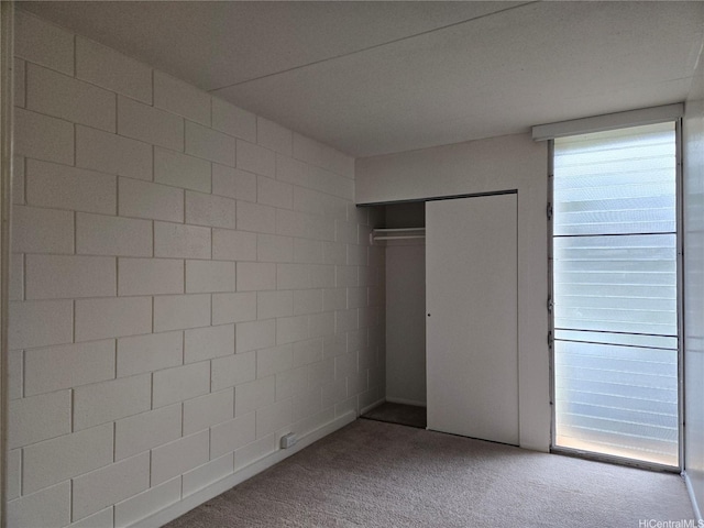 unfurnished bedroom with carpet and a closet