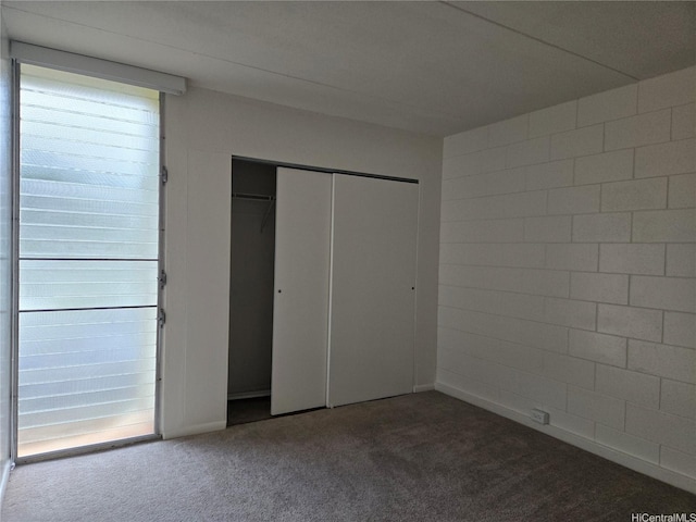 unfurnished bedroom with carpet and a closet