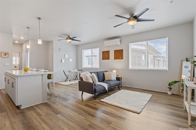 91-3575 Iwikuamoo St Unit 405, Ewa Beach, HI 96706 - living room with a wall unit AC, ceiling fan, and healthy amount of natural light