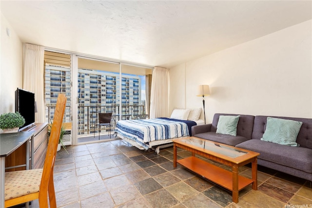 2345 Ala Wai Blvd Unit 1806, Honolulu, HI 96815 - bedroom featuring floor to ceiling windows, stone tile flooring, and access to exterior