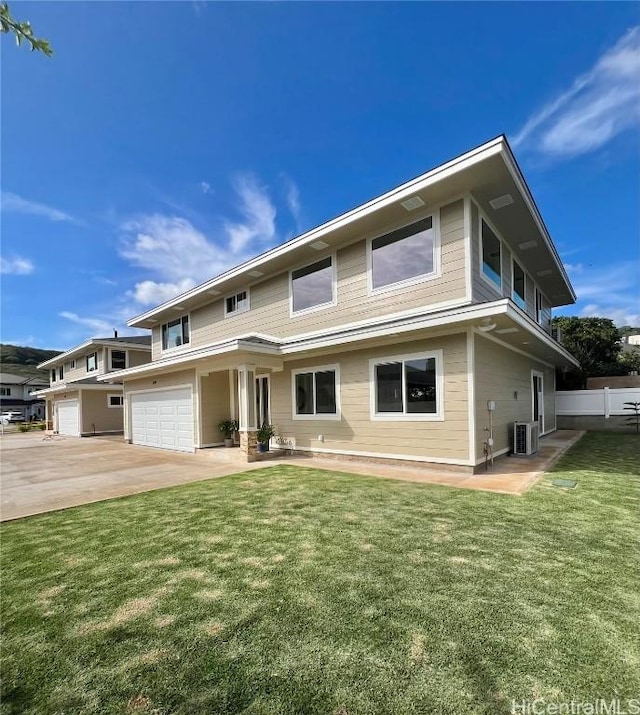 view of front facade featuring a front lawn, an attached garage, central AC, and concrete driveway