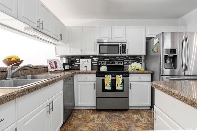 94-835 Lumiauau St Unit K105, Waipahu, HI 96797 - kitchen with appliances with stainless steel finishes, stone finish floors, a sink, white cabinetry, and decorative backsplash