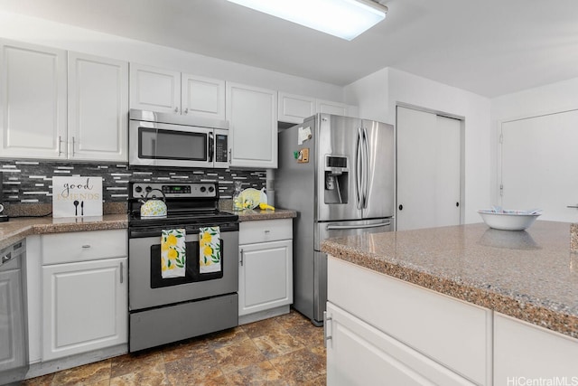 94-835 Lumiauau St Unit K105, Waipahu, HI 96797 - kitchen with appliances with stainless steel finishes, white cabinets, tasteful backsplash, and stone finish flooring