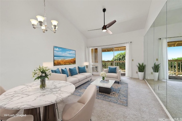 living area with heating unit, ceiling fan with notable chandelier, high vaulted ceiling, and carpet