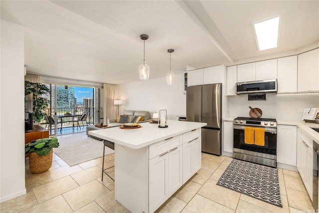 kitchen with white cabinets, stainless steel appliances, and light countertops