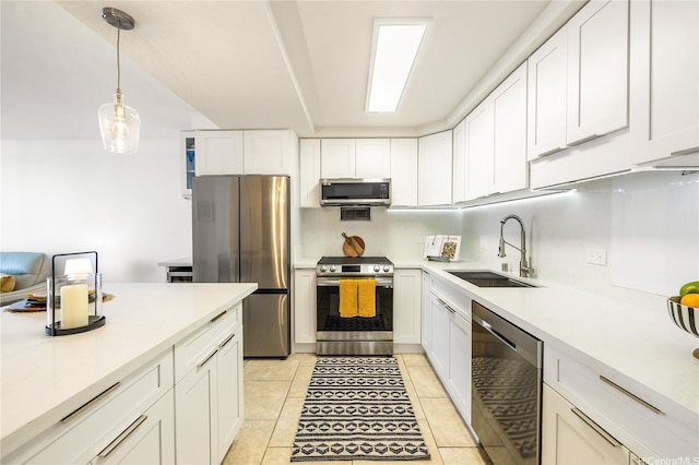 kitchen featuring white cabinetry, stainless steel appliances, light countertops, and a sink