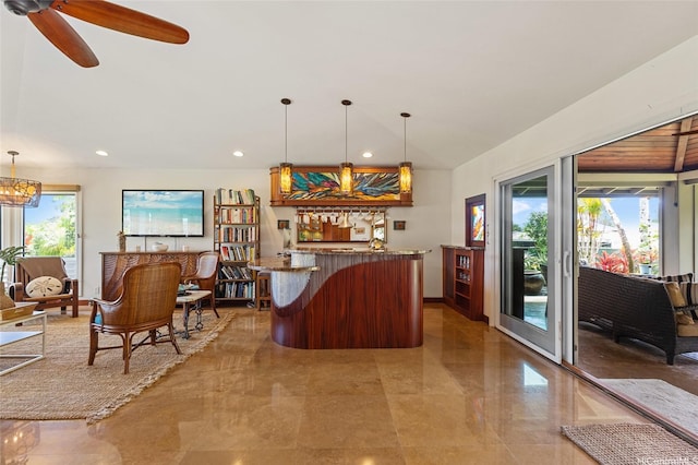 bar with recessed lighting, ceiling fan, hanging light fixtures, and bar area