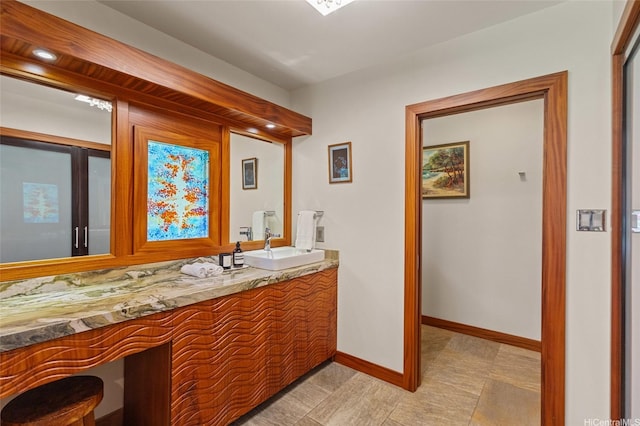 bathroom with baseboards and vanity
