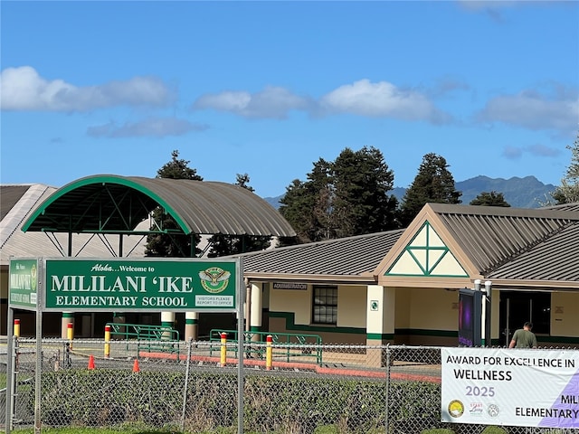 95-1023 Hehina St, Mililani, HI 96789 - view of building exterior with a mountain view and fence
