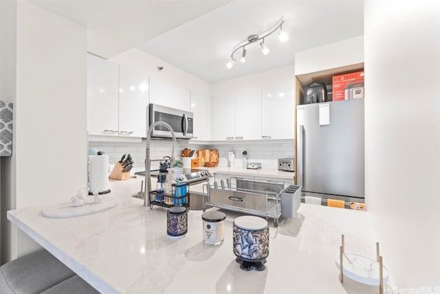 415 S St Unit 302, Honolulu, HI 96813 - kitchen with white cabinetry, appliances with stainless steel finishes, and decorative backsplash