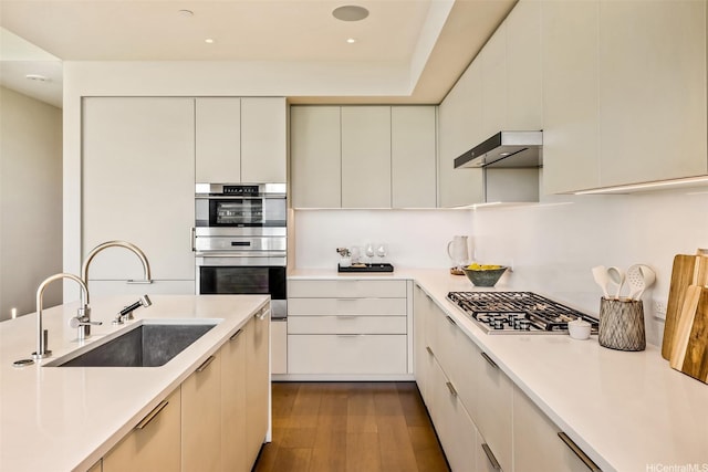 1388 Ala Moana Blvd Unit 7601, Honolulu, HI 96814 - kitchen featuring a sink, appliances with stainless steel finishes, light countertops, dark wood-style floors, and recessed lighting
