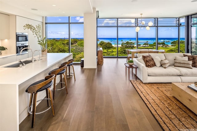 1388 Ala Moana Blvd Unit 7601, Honolulu, HI 96814 - living room featuring expansive windows, dark wood-style flooring, and a water view