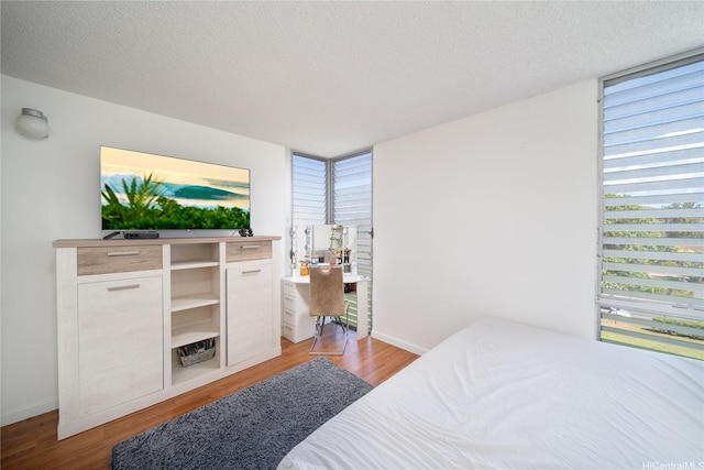 bedroom featuring a textured ceiling and light wood-style floors