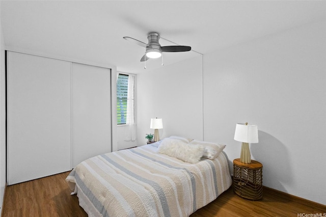 bedroom with a closet, wood finished floors, and ceiling fan