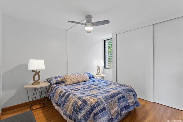 bedroom featuring a closet, wood finished floors, and a ceiling fan