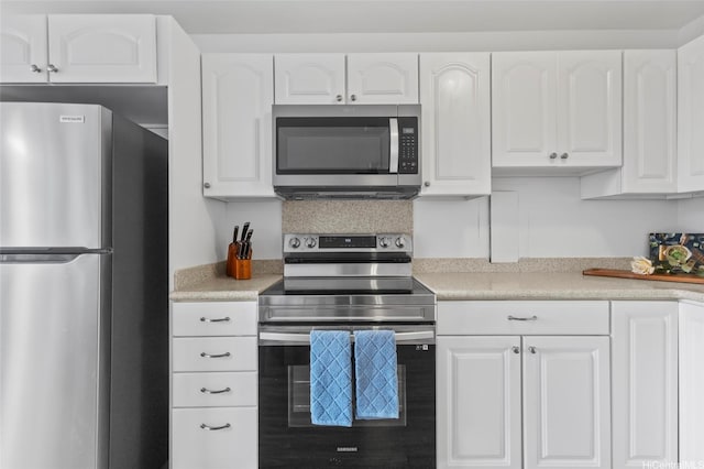 kitchen featuring light countertops, appliances with stainless steel finishes, and white cabinetry