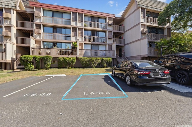 view of property featuring uncovered parking