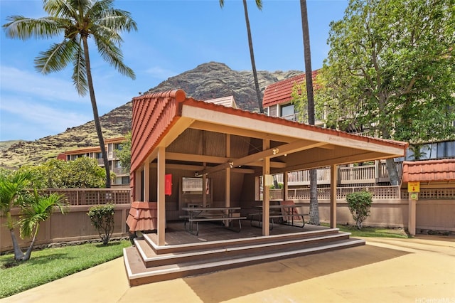 surrounding community featuring a mountain view and fence